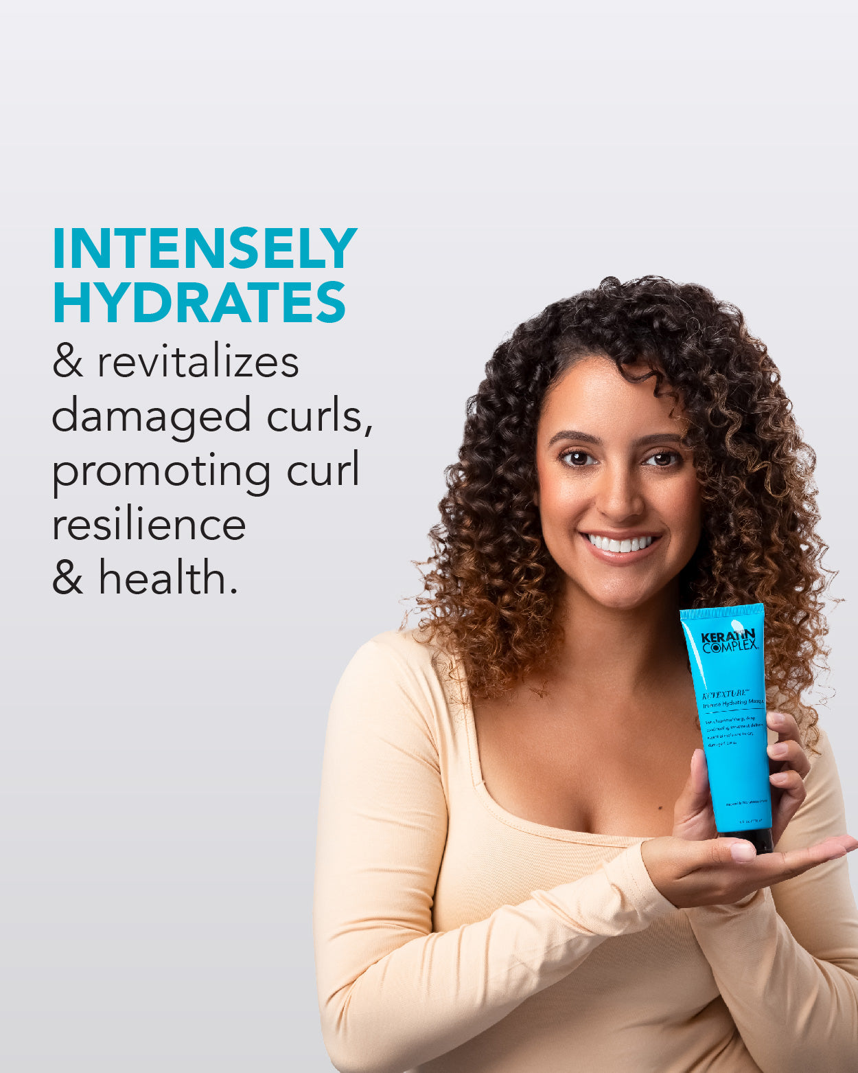 Model holding KCTEXTURE hydrating masque with soft defined natural curls