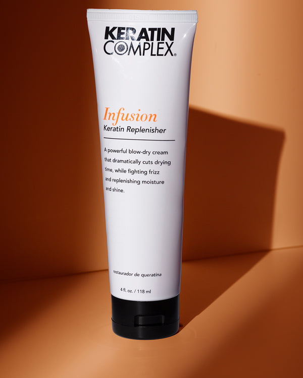 A bottle of Keratin Complex UK Infusion on a brown background 