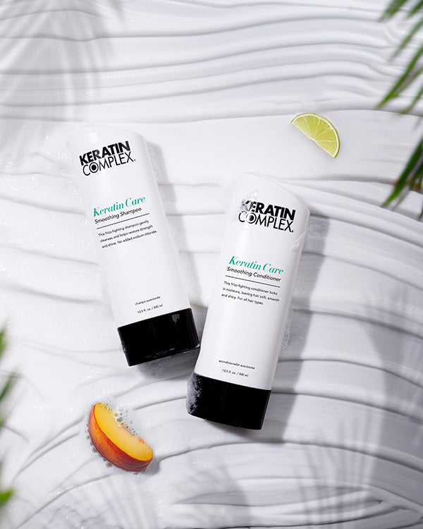 Keratin Care Smoothing Shampoo 400ml and conditioner 400ml on a white textured background with limes