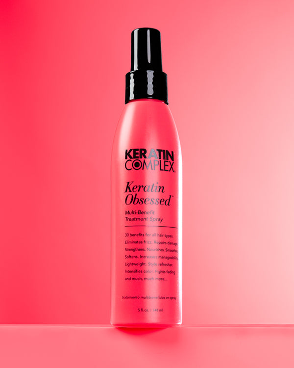 Keratin Obsessed bottle on a pink background - Keratin Complex UK